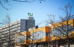 The cafeteria and the math tower with the logo of TU Dortmund University on top and blue sky in the background